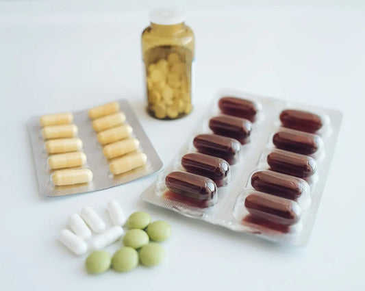 a table topped with pills and a bottle of pills