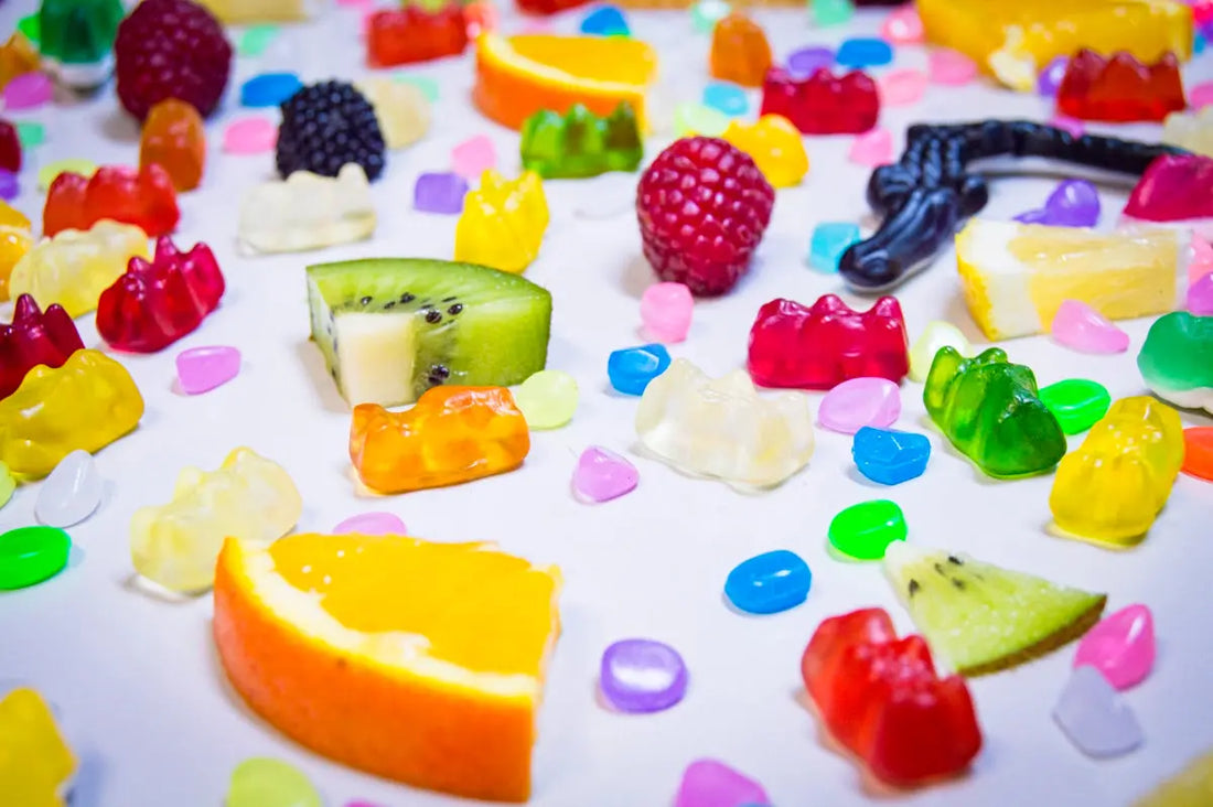Assortment of colorful gummy candies and fruit slices.